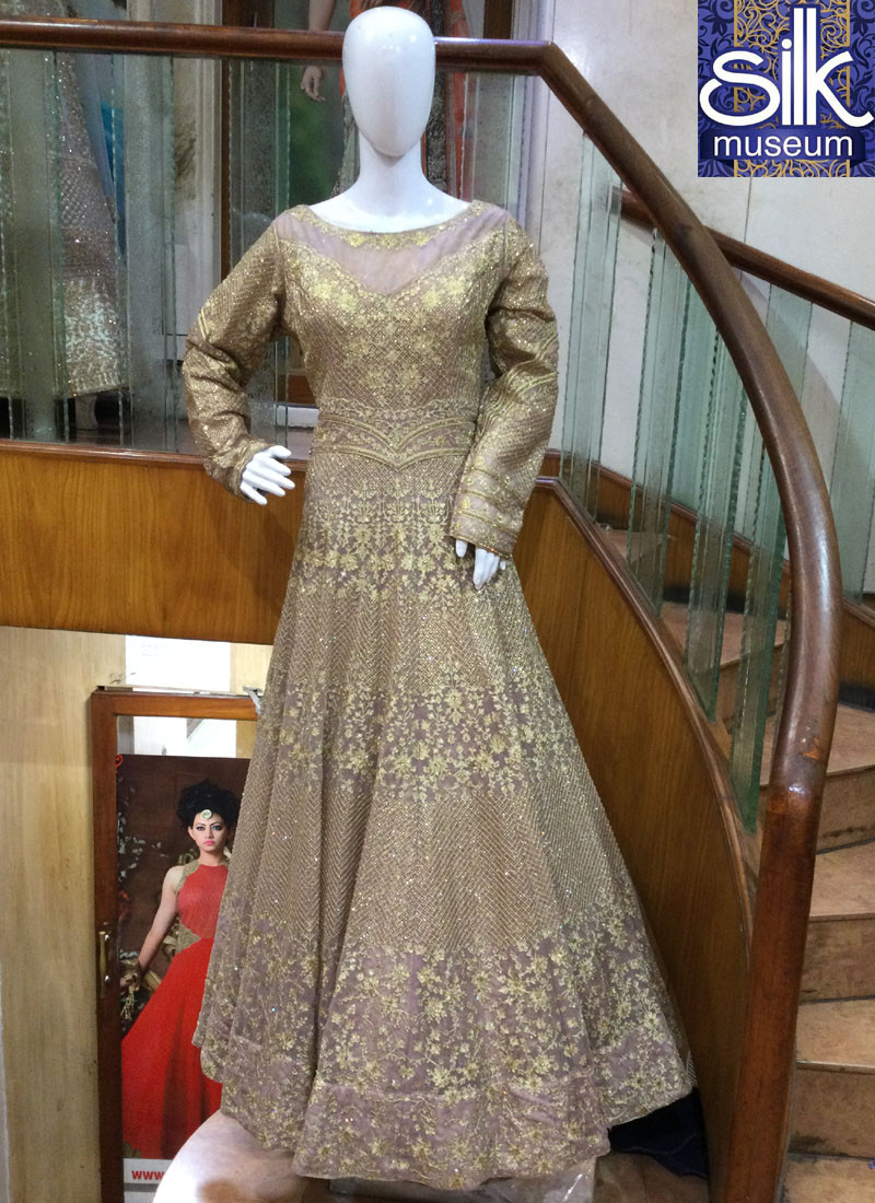 14349 Mesmerizing Outfit in Sapota Color Net Designer Wedding Wear